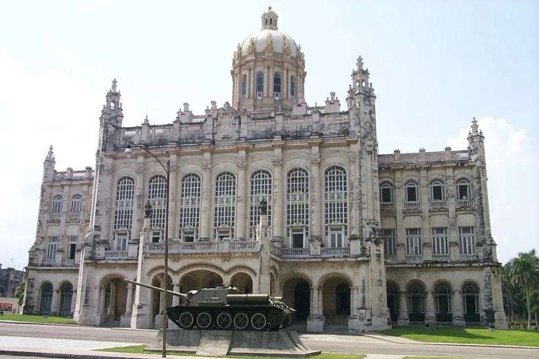 old building with large turret and old tanks outside