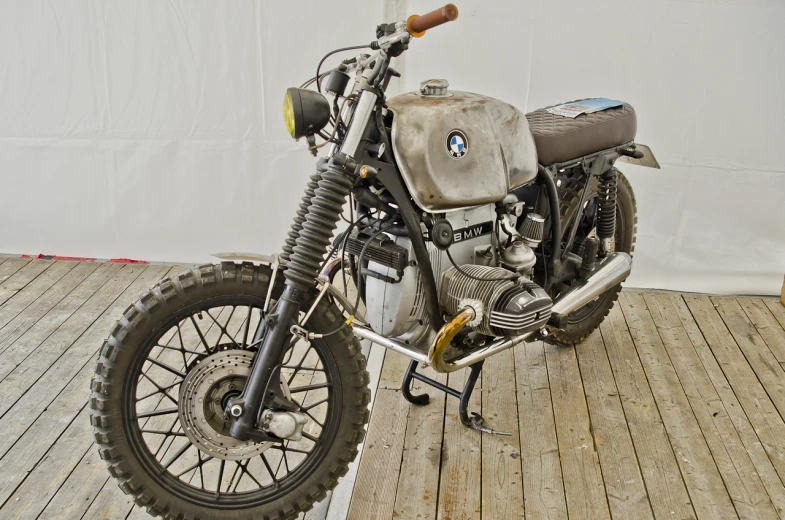 a motorcycle parked on a wooden deck