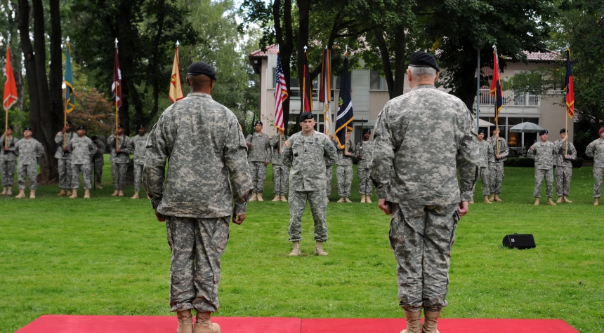 several men in military camouflage are at a ceremony