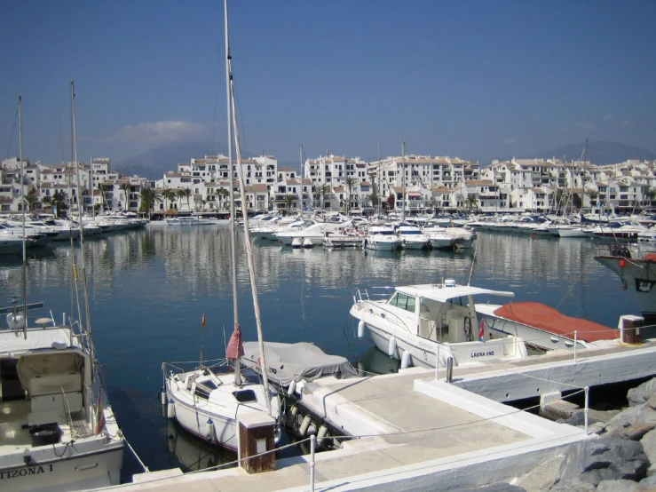 some white boats are docked in the harbor