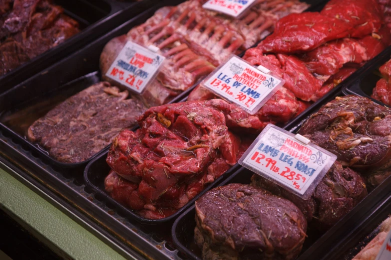 a group of meat stands in plastic containers