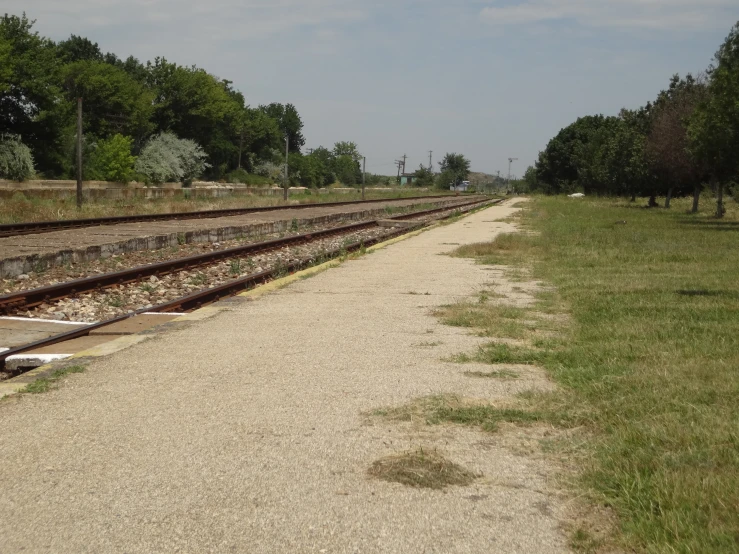 a long empty, empty train track in the middle of nowhere