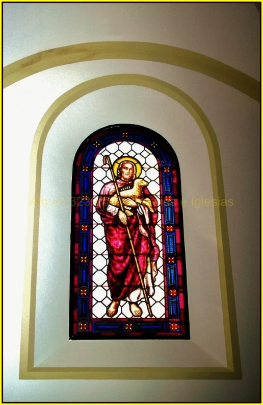 a stained glass window of jesus in the shape of a cross
