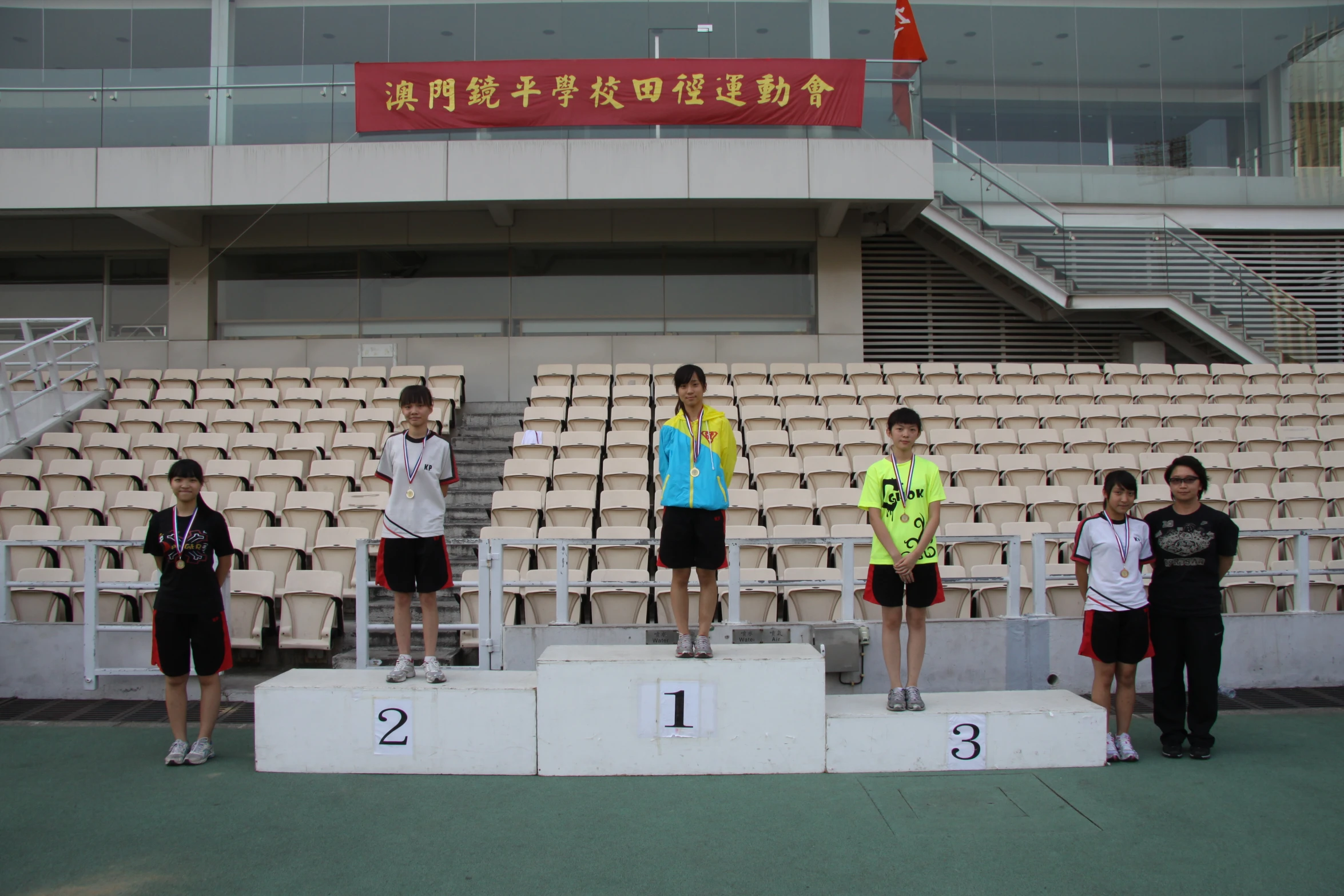 a group of people standing on top of a podium