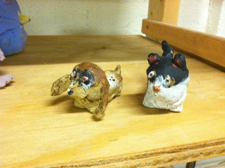 there are two small animal figures sitting on a table
