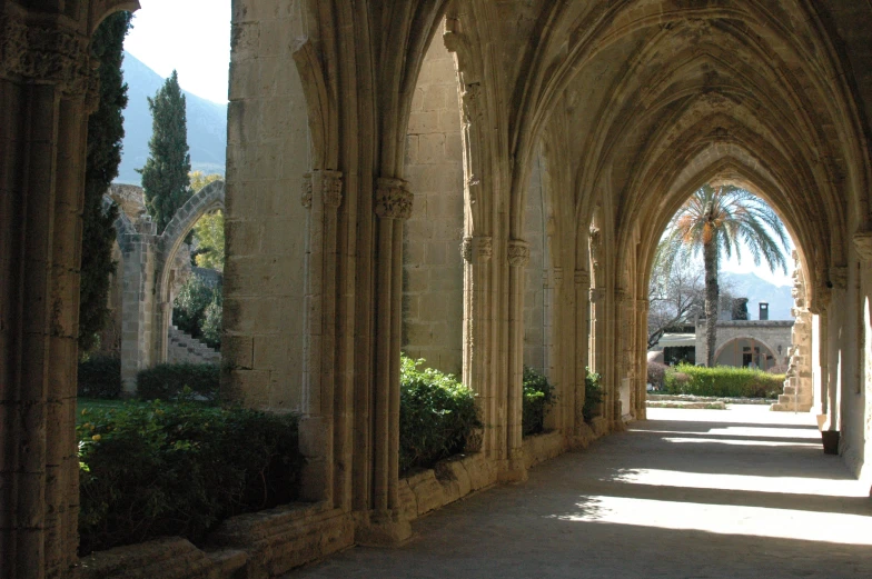 the inside of a long stone building with columns and arches