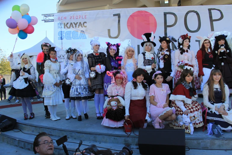 the group of people are dressed up as they wait to perform