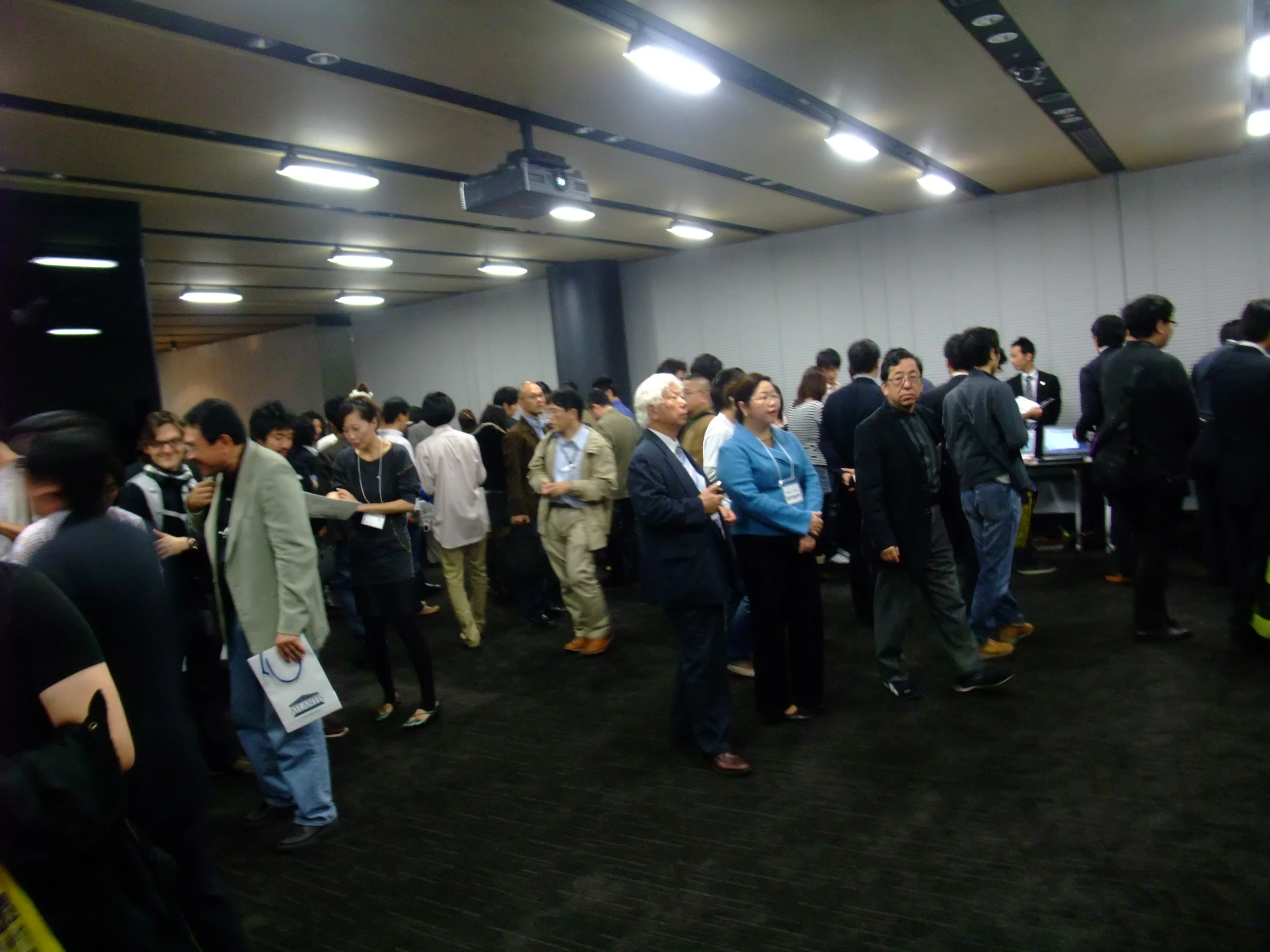 a group of people standing around in an empty room