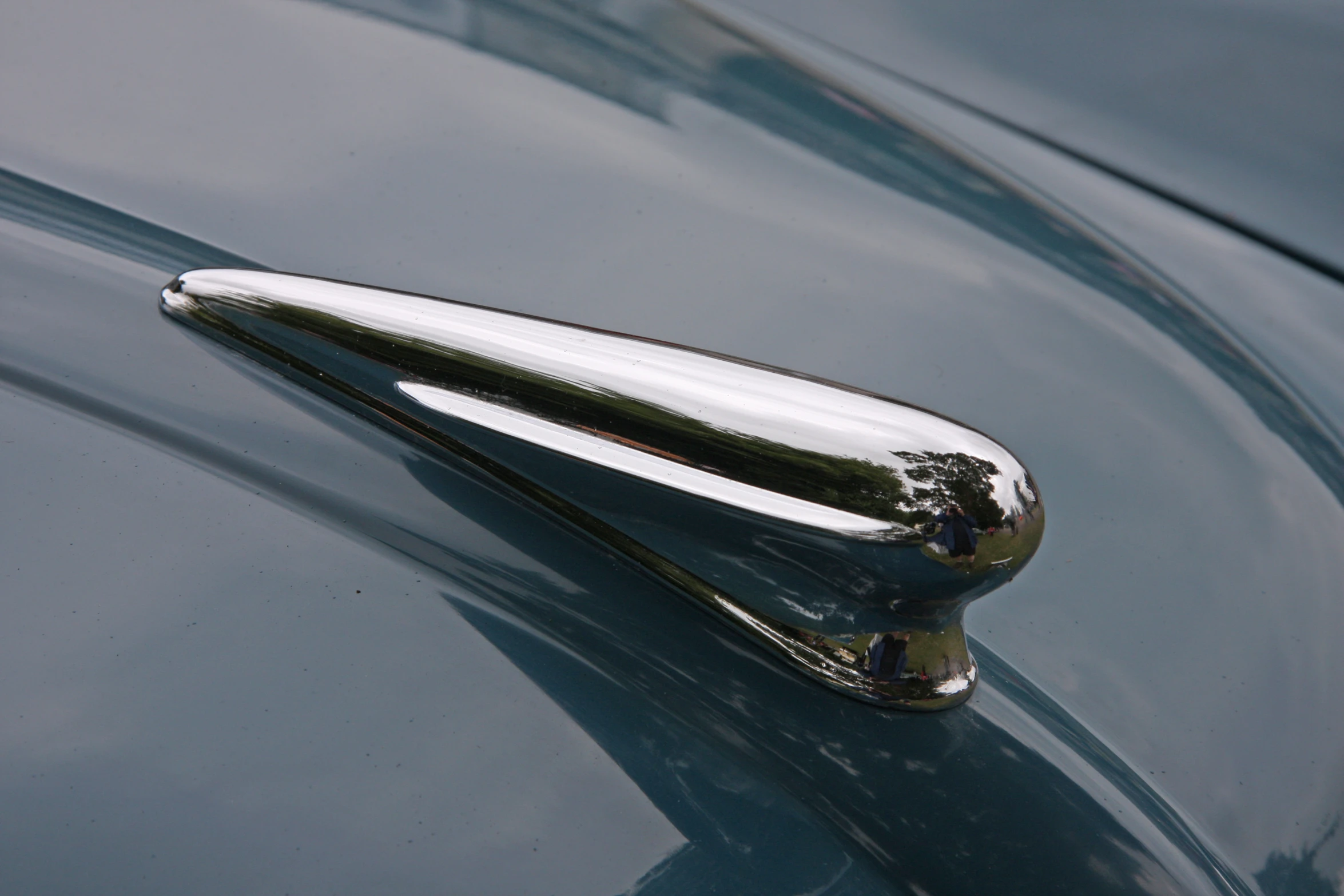 chrome handles and door handle on a shiny blue classic car