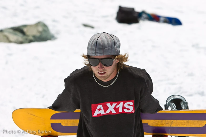 man with long hair, wearing sunglasses and a t - shirt that says ax's