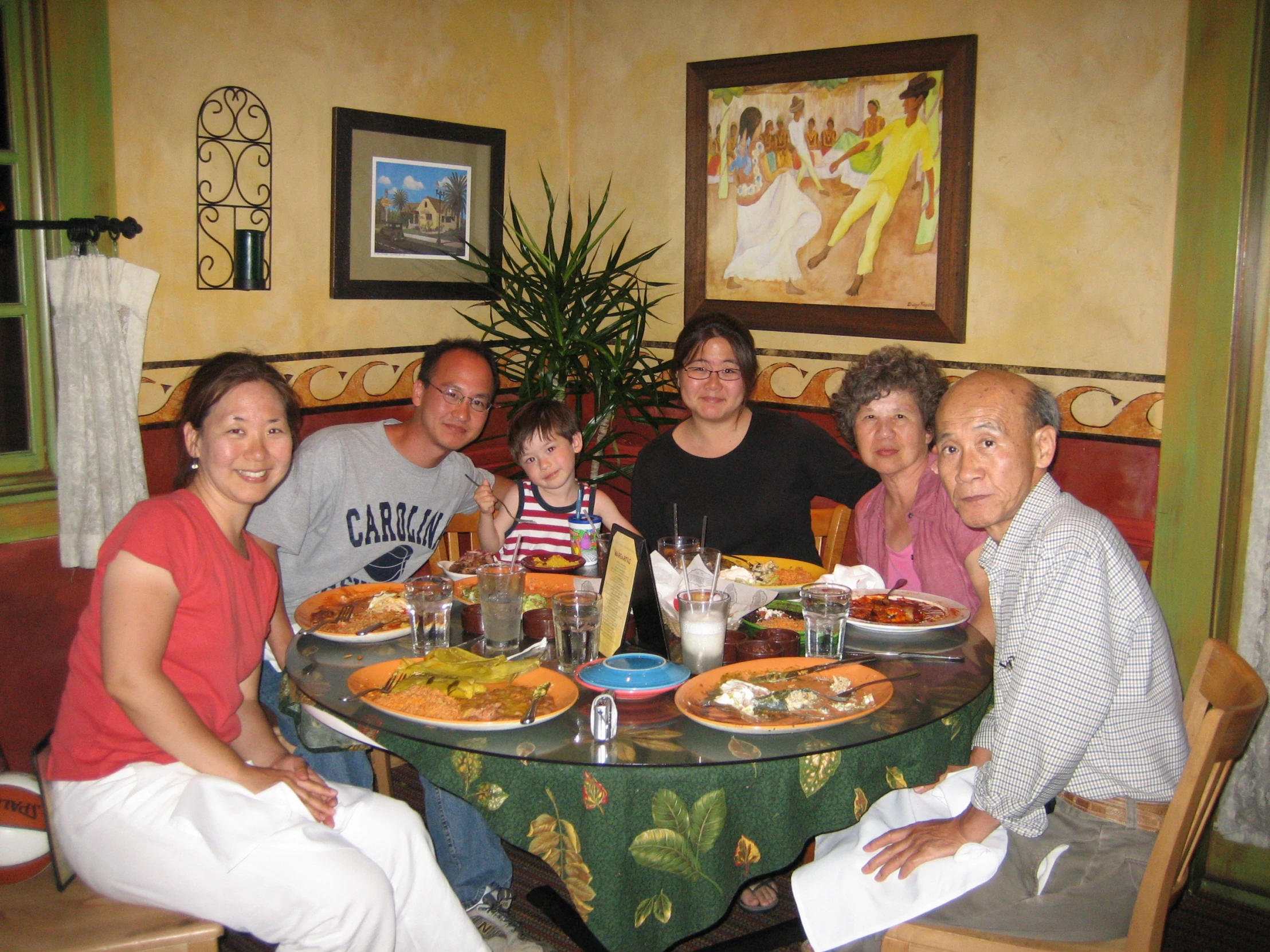 a family sitting at a dinner table ready to eat