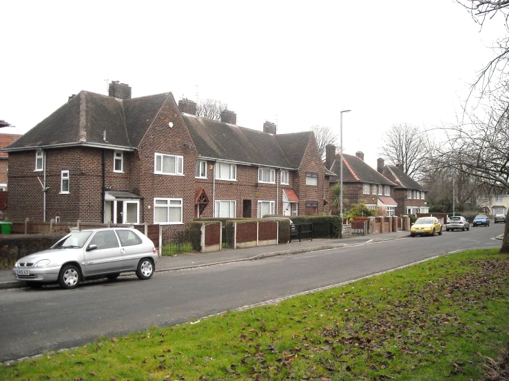 a silver car is parked near the side walk