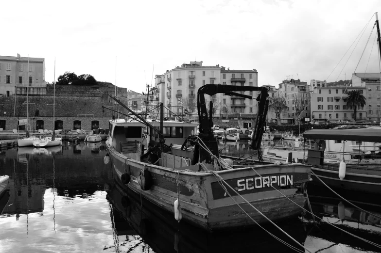 small boats sit in the water in front of a city