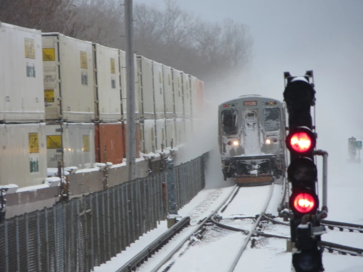 a train is running through a snowy railroad track