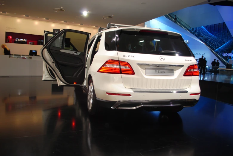 the rear end of a white mercedes benz car