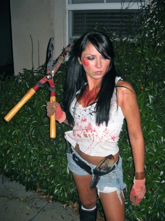 a girl wearing makeup and holding two y hammers