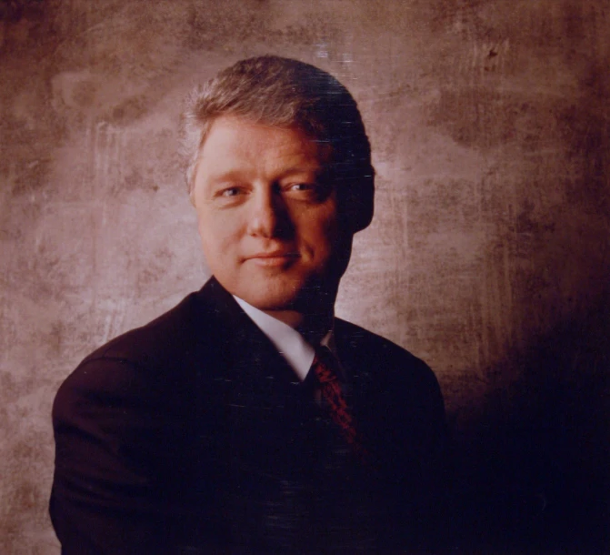 a man in a black suit and red tie