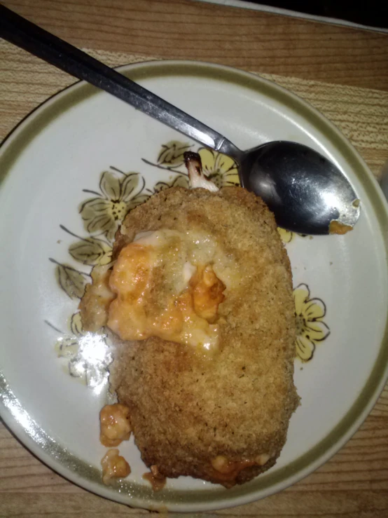 an oval white plate with a dessert and a fork