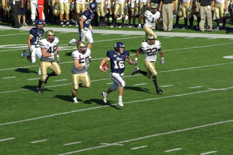 two football teams running a game on grass