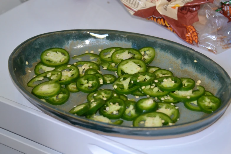 fresh jalapenos in a pan on top of the stove