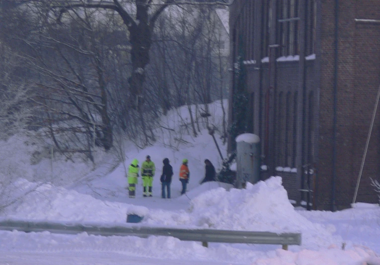 a group of people standing next to each other outside of a building