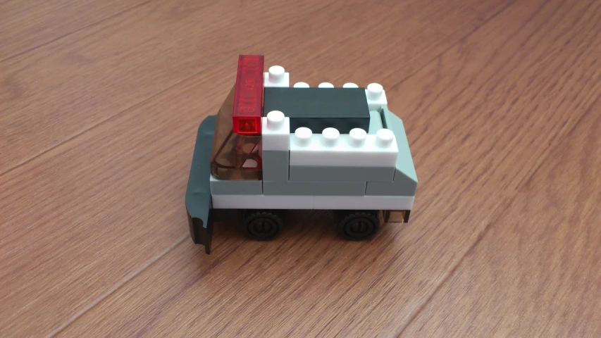 a toy truck with a small brick on top of it