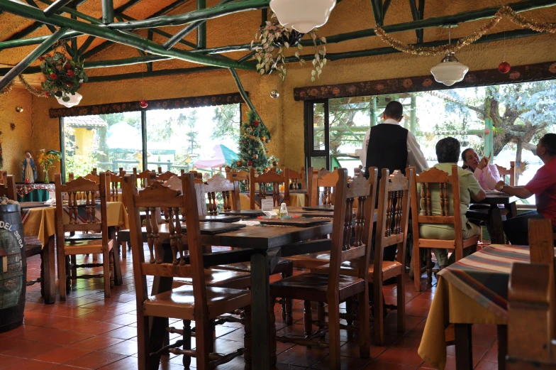 a restaurant with people standing inside of it