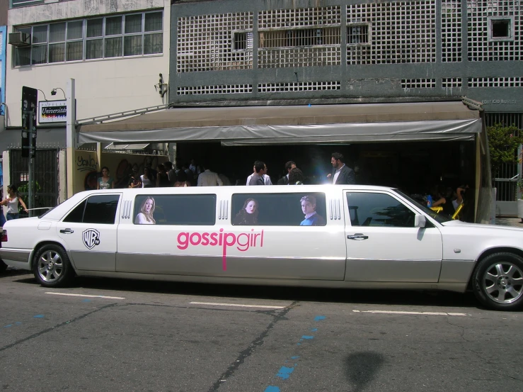 a wedding limousine with bride and grooms sitting in the backseat