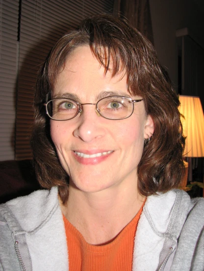a woman with glasses is looking at the camera
