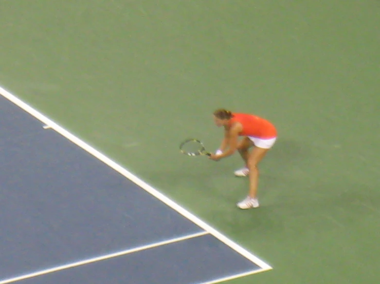 a person on a tennis court with a racket