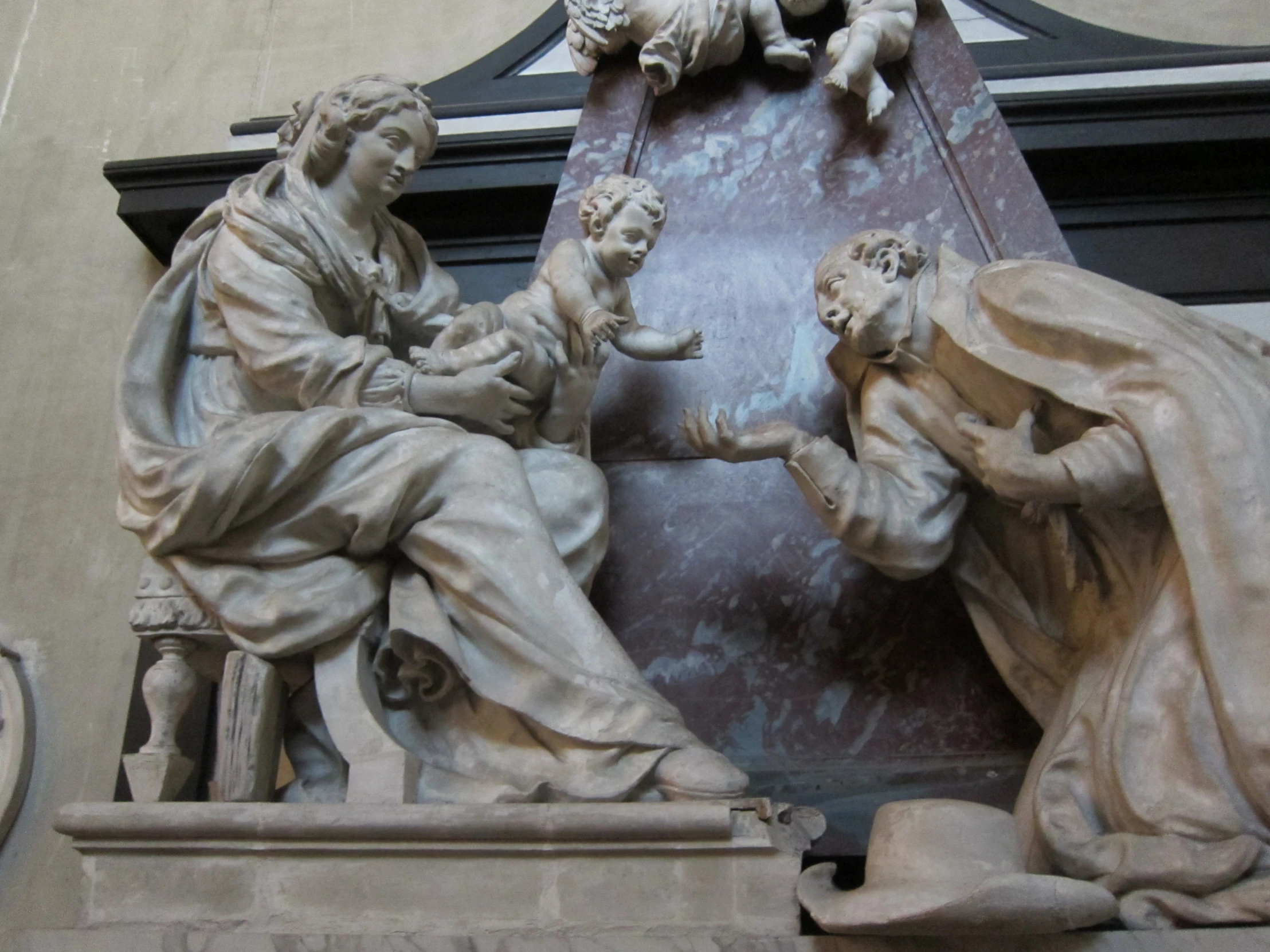 a clock with statues of people pointing to the sky