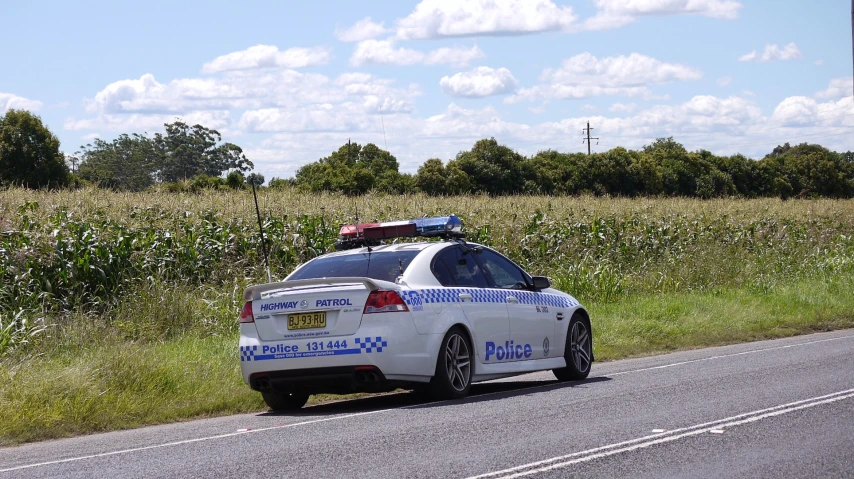 a police car parked on the side of a road