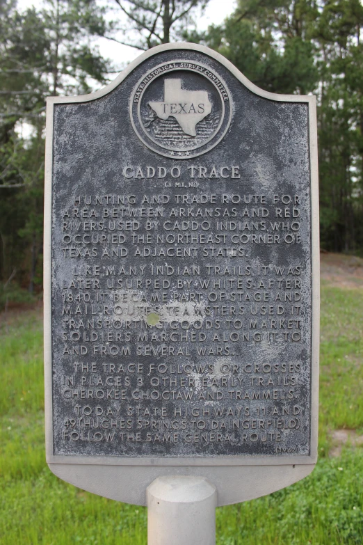 a plaque with words written about the location of caddo track