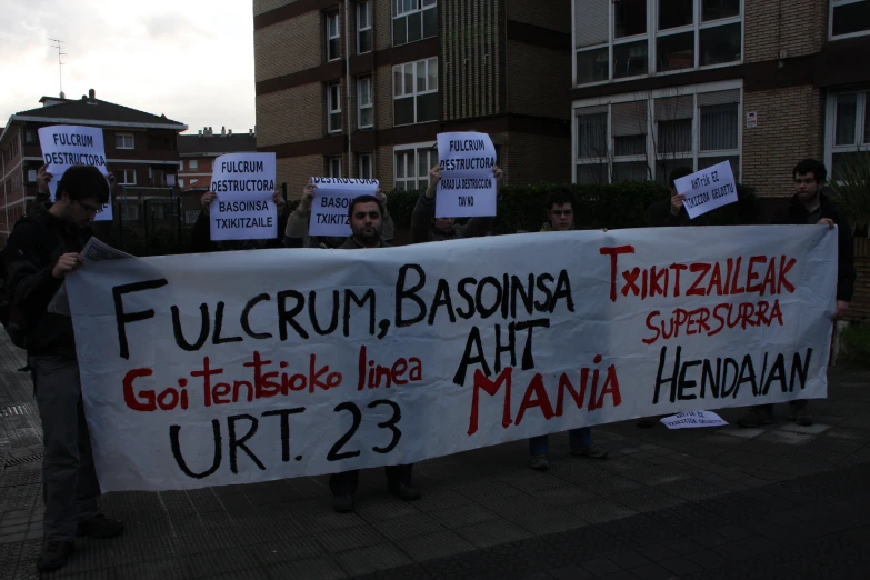 several people holding a sign that reads fucrum, boronga, taunta zhenora and go terate