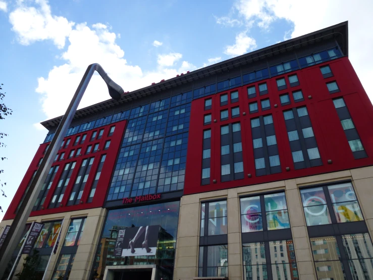 a building with lots of windows near a traffic sign