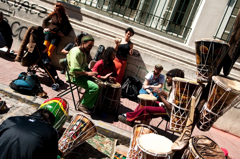 an audience sitting on steps near buildings on their cell phones