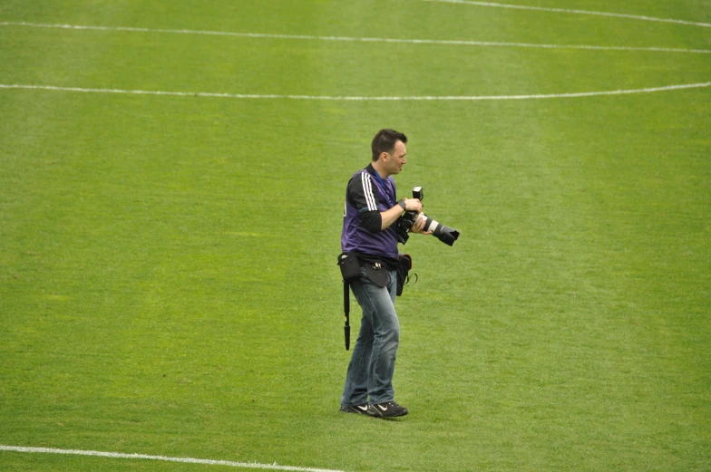 a pographer is taking pictures of a soccer field