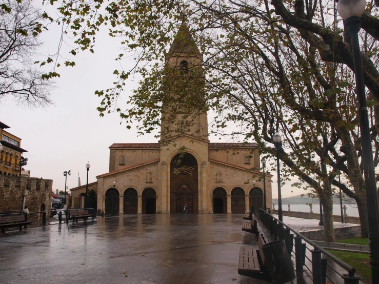 a tower with a clock is at the end of a walkway