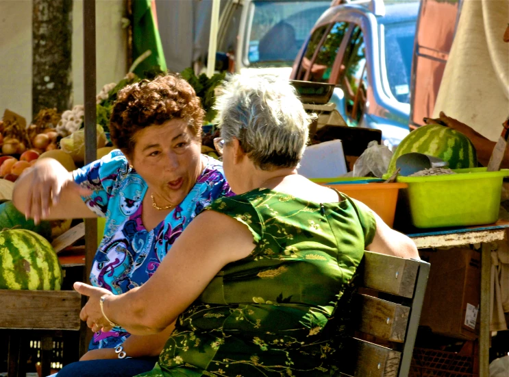 two women sharing a laugh at the market