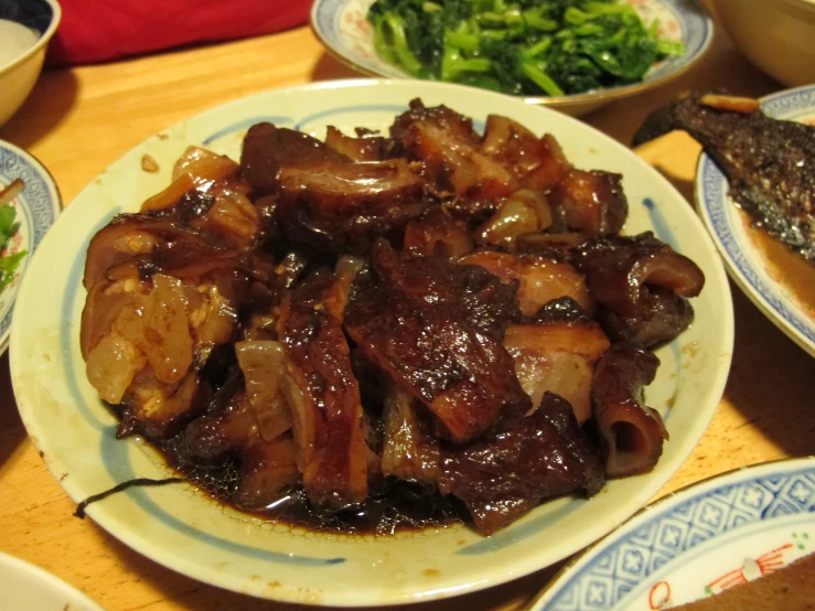 a large plate with meat and vegetables on it