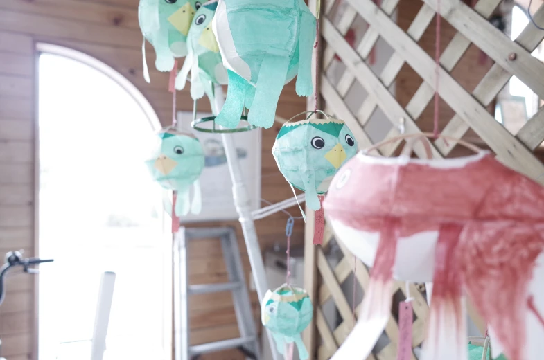 several stuffed owls are hanging from a ladder