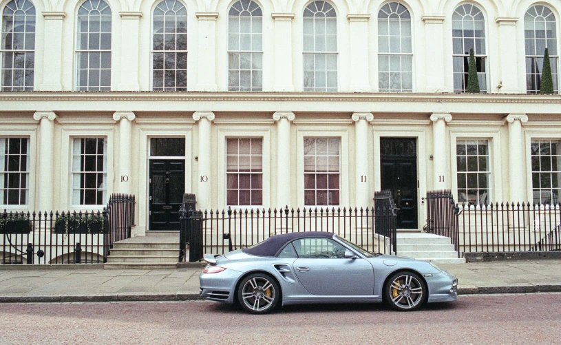 a grey sports car parked on a street