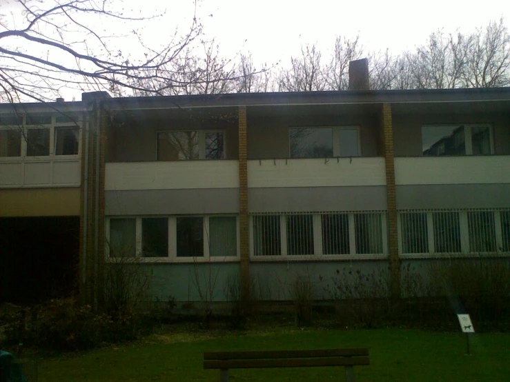 an old building with three windows on the upper floor