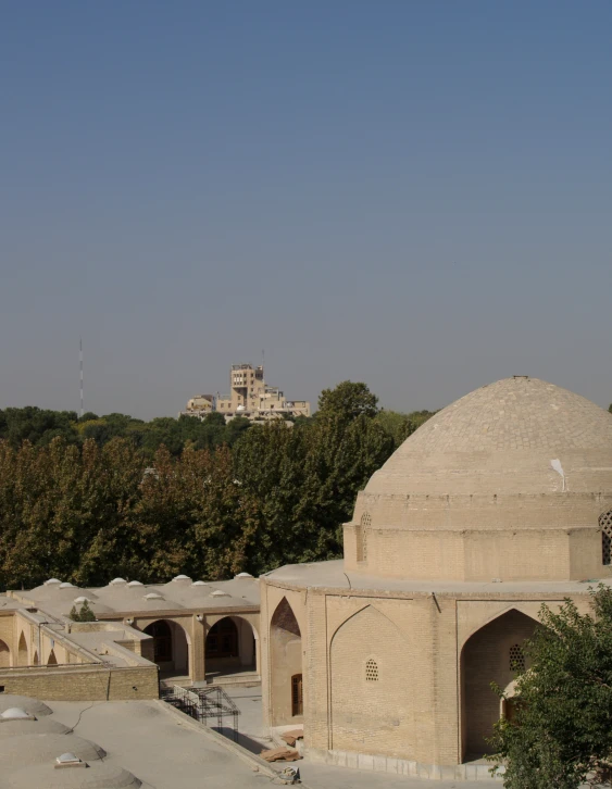 the large dome is near a building in a courtyard