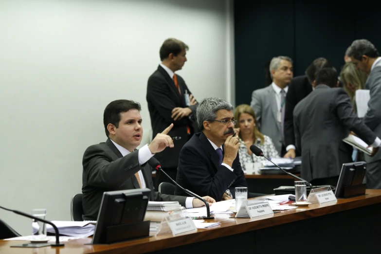 many business men sitting at a table having a meeting