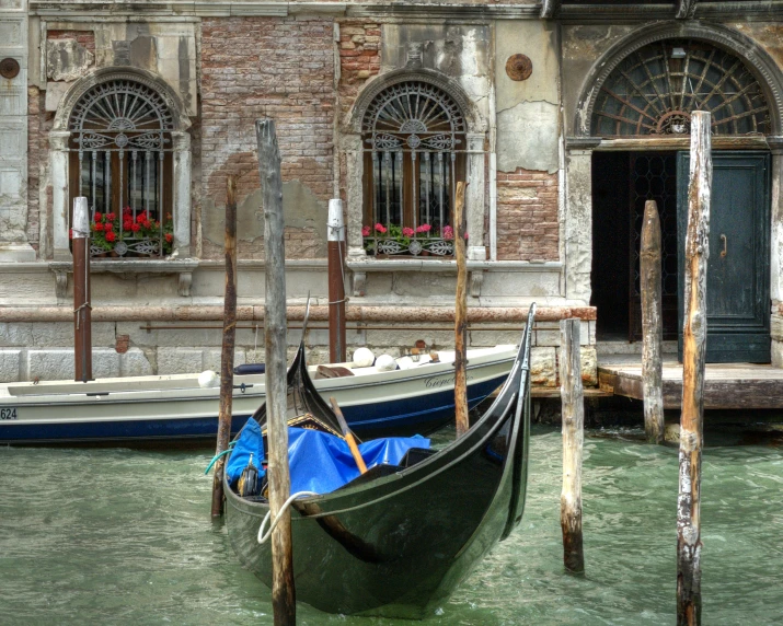 the gondola is tied up beside a building