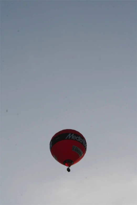 a red  air balloon is flying in the air