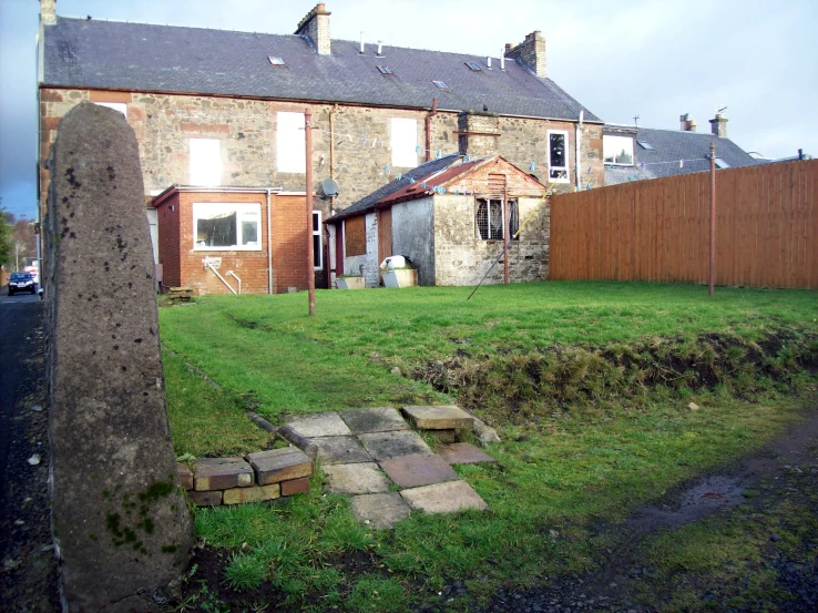 a brick building behind a stone slab