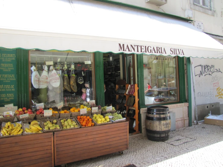 an outside store is selling fruit and vegetables