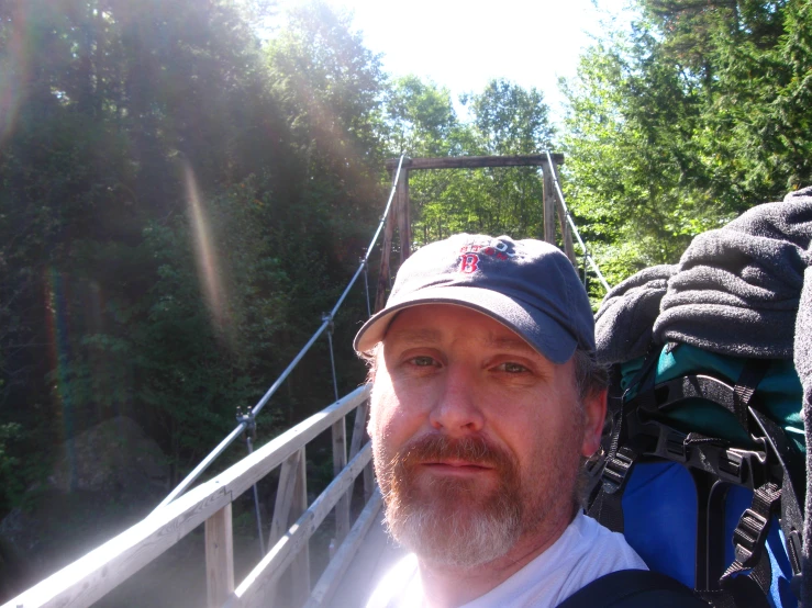 a man with a backpack on a bridge